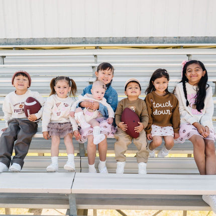 Kids wearing fun football themed outfits 
