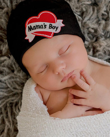 Baby wearing black hat with "Mama's Boy" heart tattoo patch