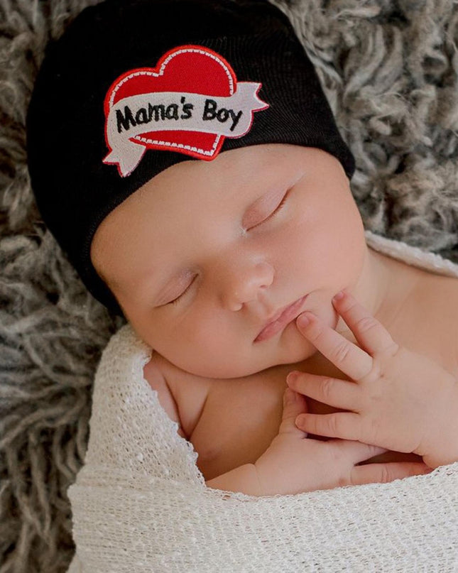 Baby wearing black hat with "Mama's Boy" heart tattoo patch