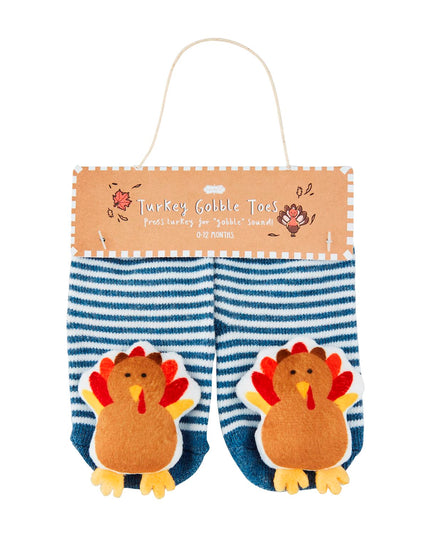 Pair of blue and white striped baby socks with turkeys on them