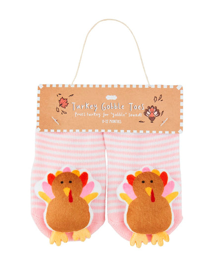 Pair of pink and white striped baby socks with turkeys on them