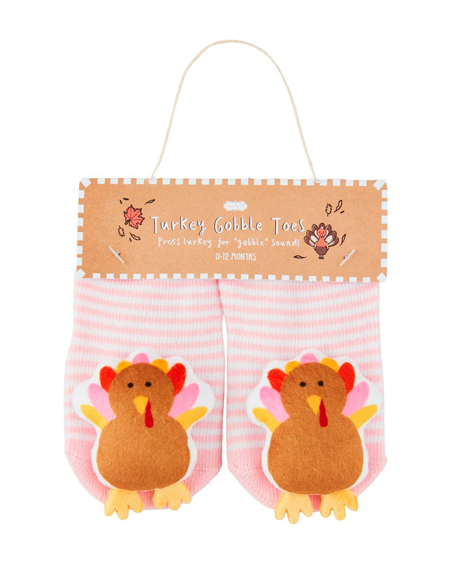 Pair of pink and white striped baby socks with turkeys on them
