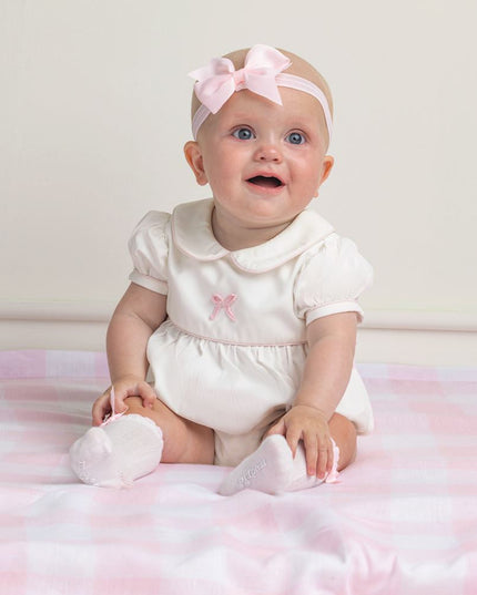 Baby Wearing White knee-high  socks with bow