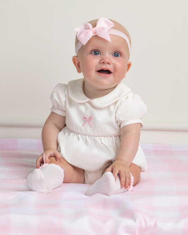 Baby Wearing White knee-high  socks with bow
