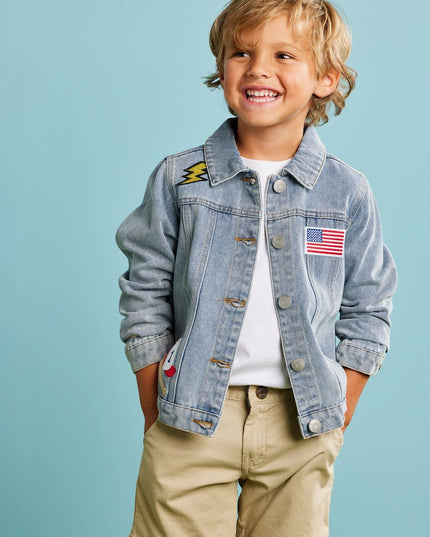 Child wearing a denim jacket with patches 
