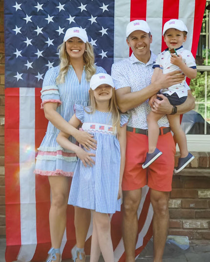 Family wearing matching American flag hats