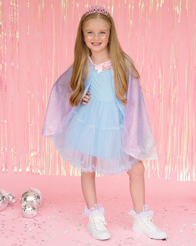 Girl wearing rainbow sequin dress up cape and pink crown