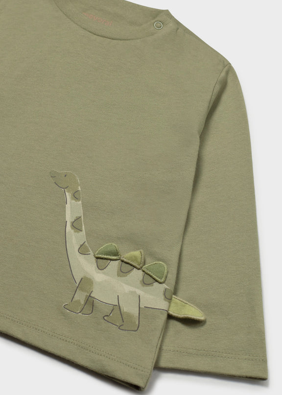 An olive green long-sleeve children's t-shirt featuring a 3D appliqué dinosaur design on the front