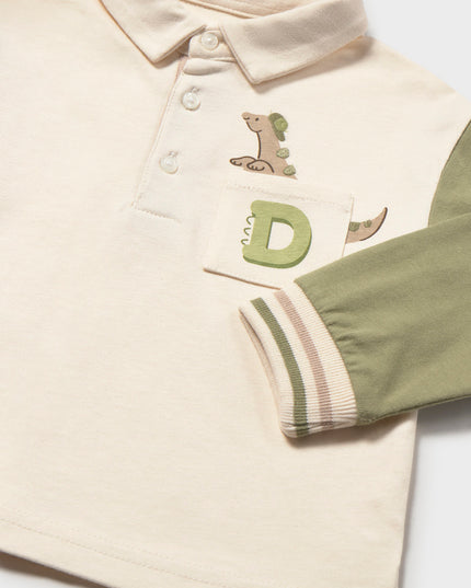 Children's long sleeve polo shirt with green sleeves and a pocket featuring a dinosaur peeking out