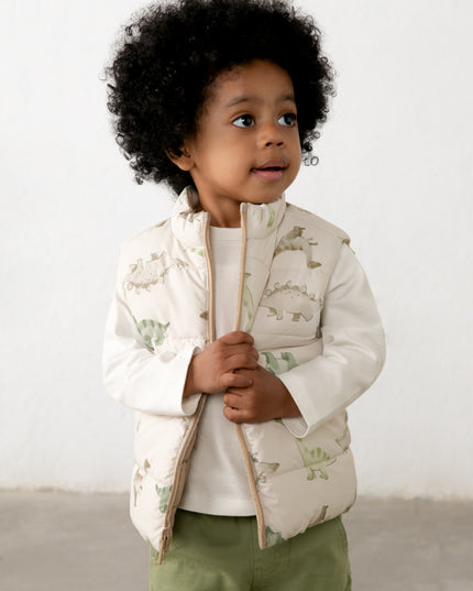 Child wearing a dinosaur patterned vest