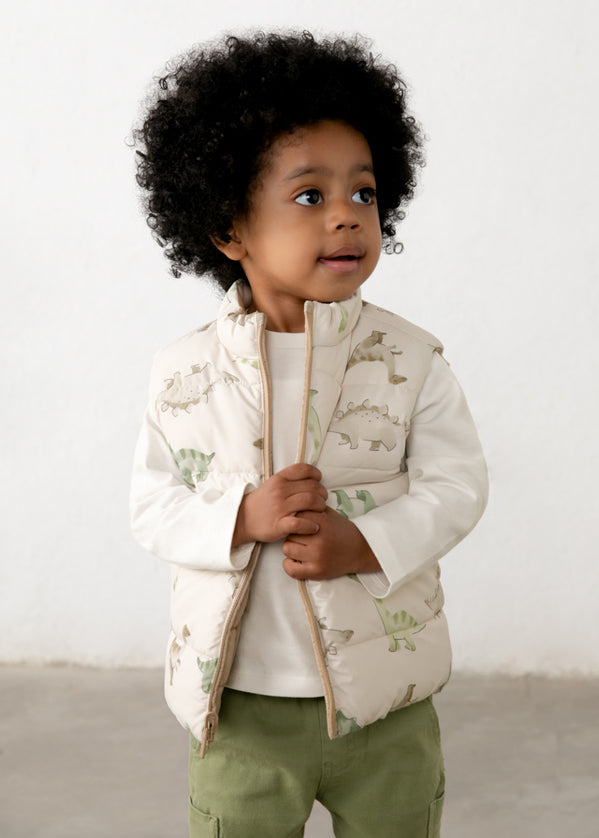 Child wearing a dinosaur patterned vest