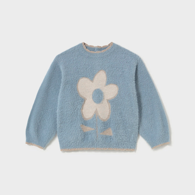 A light blue fuzzy long-sleeve sweater with a large cream-colored flower