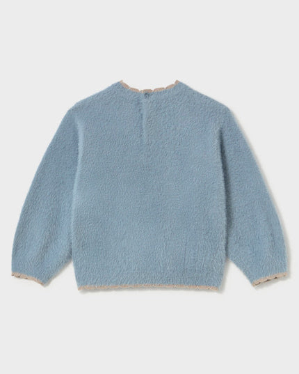 A fuzzy light blue sweater