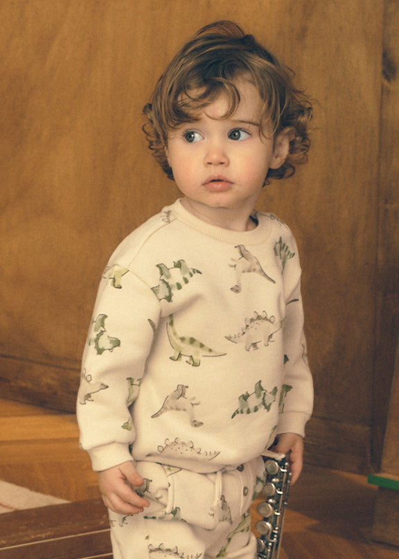 Boy wearing Beige sweatshirt with dinosaur print