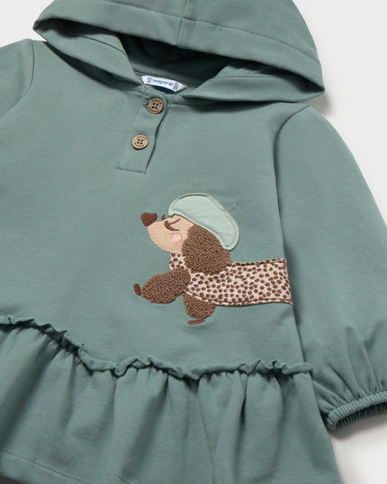 Green hooded dress with a brown and white spotted dog appliqué 