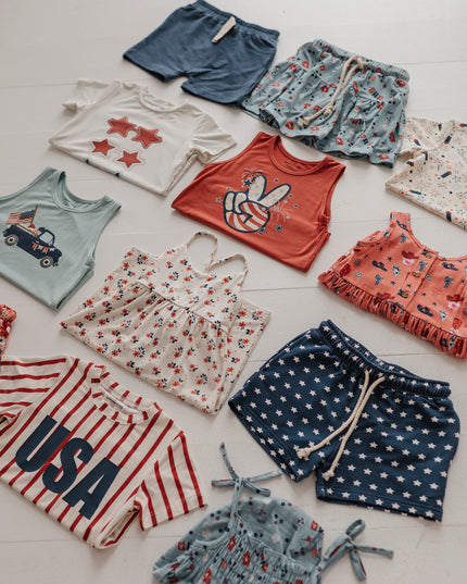 flat lay of kid's red, white and blue clothing 