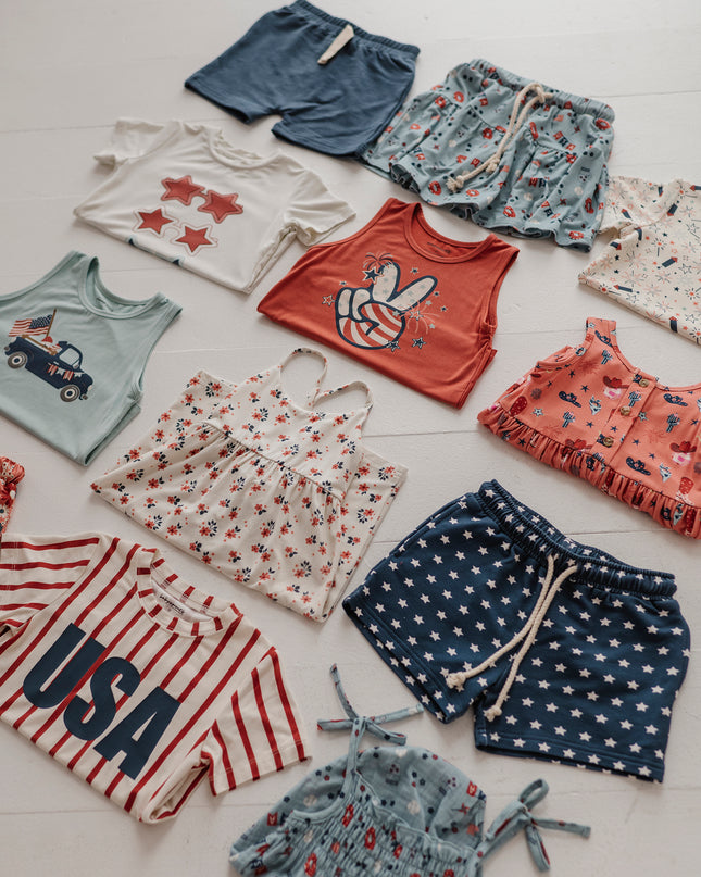 flat lay of kid's red, white and blue clothing 