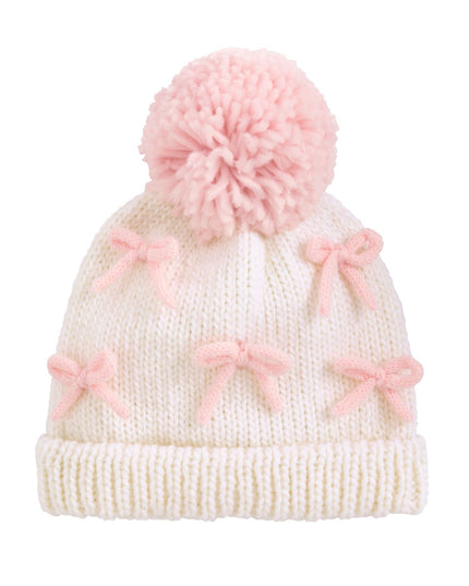 White knit hat with pink bows and a pom-pom 