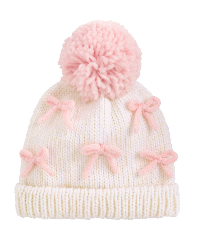 White knit hat with pink bows and a pom-pom 