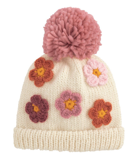 Knitted hat with pink pom-pom and colorful flowers