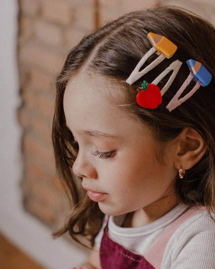Girl wearing Set of three hair clips with an apple, blue pencil, and and yellow pencil design