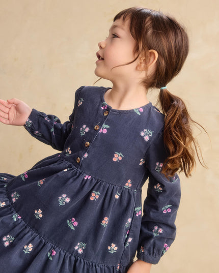 a young girl wearing a deep midnight corduroy shirtdress with floral pattern 