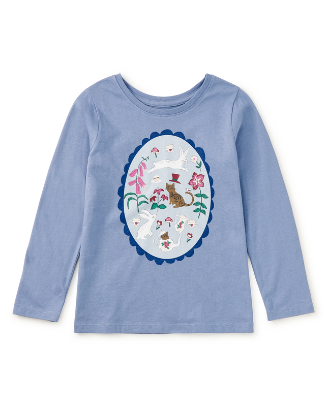 A light blue long-sleeve crewneck shirt for kids, featuring a large oval graphic print on the front with a whimsical cat and tea party design