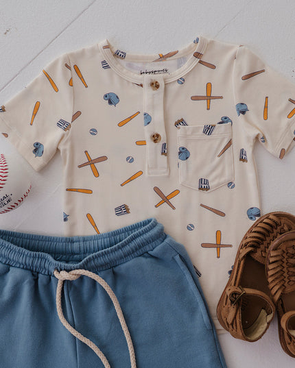 Children's outfit with baseball shirt, shorts, and shoes. 