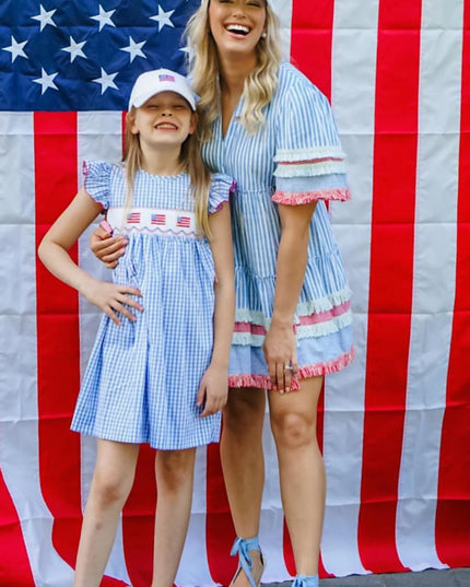 Woman and girl wearing matching American flag baseball hats