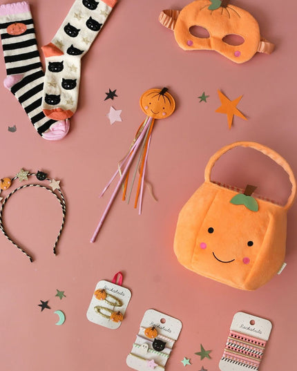 Collection of Halloween-themed accessories including socks, mask, headband and purse.