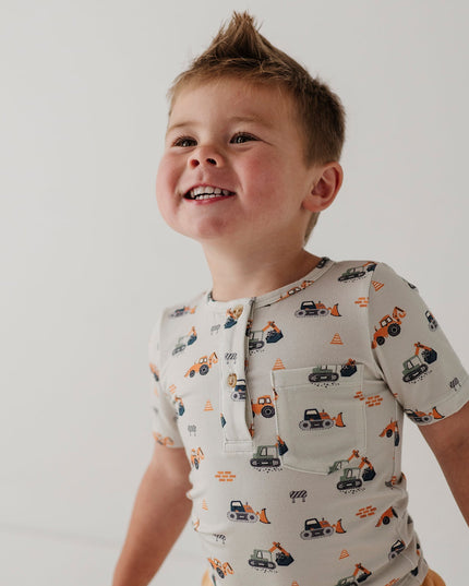 Child wearing henley shirt with construction truck print