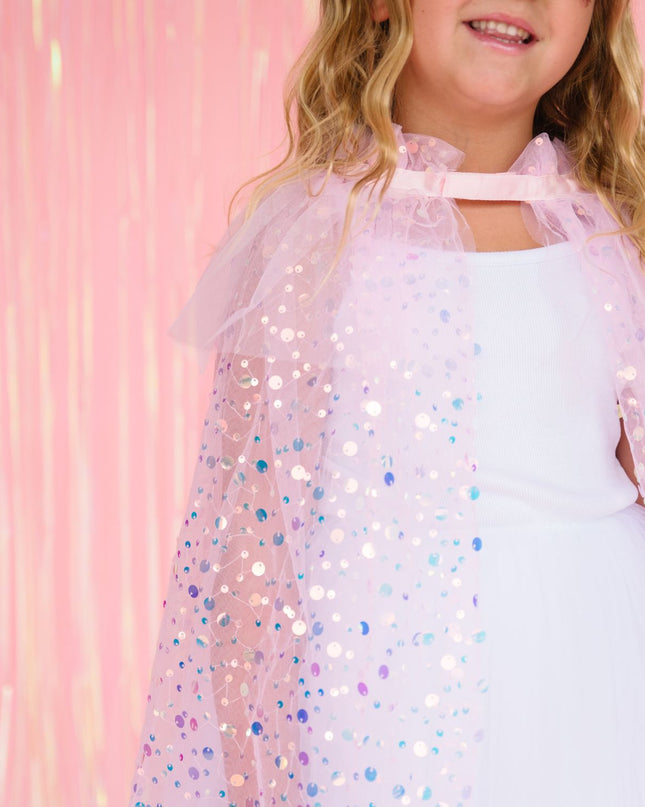 Girl wearing pink sequin cape 