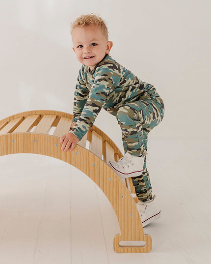 A child wearing a matching camouflage sweatshirt and jogger pants set