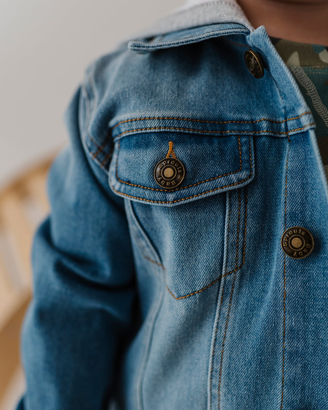Closeup of child wearing hooded denim jacket