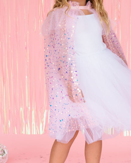 Girl wearing pink sequin cape 