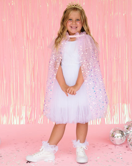 Girl wearing pink sequin cape and gold crown 