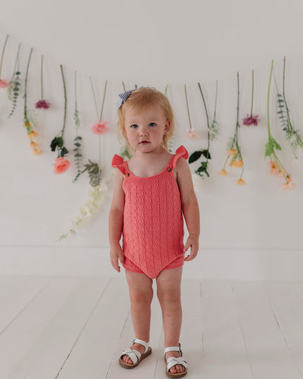 Baby in a red knit bodysuit