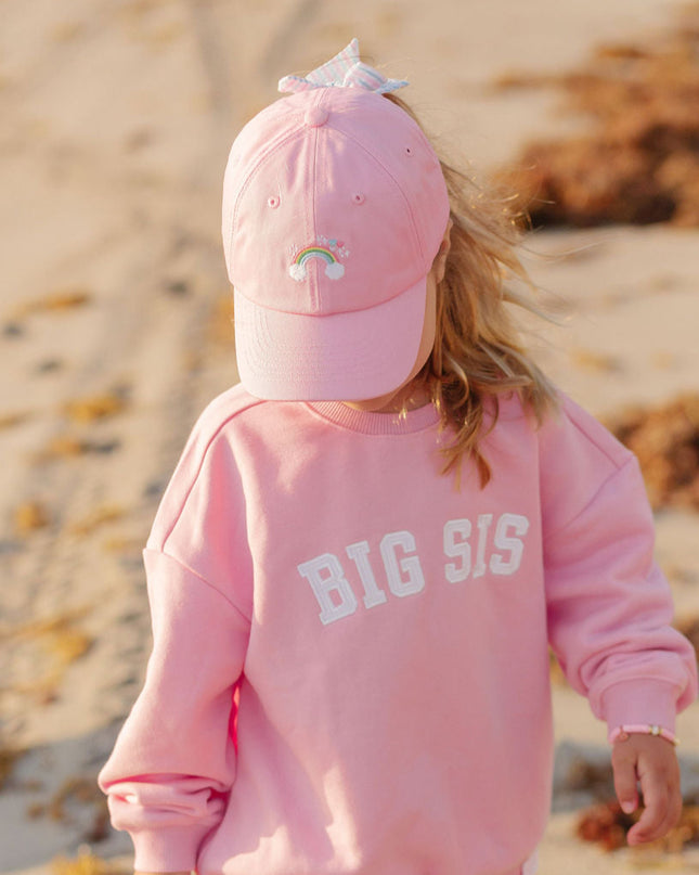 girl wearing Rainbow Sparkle Bow Baseball Hat on beach