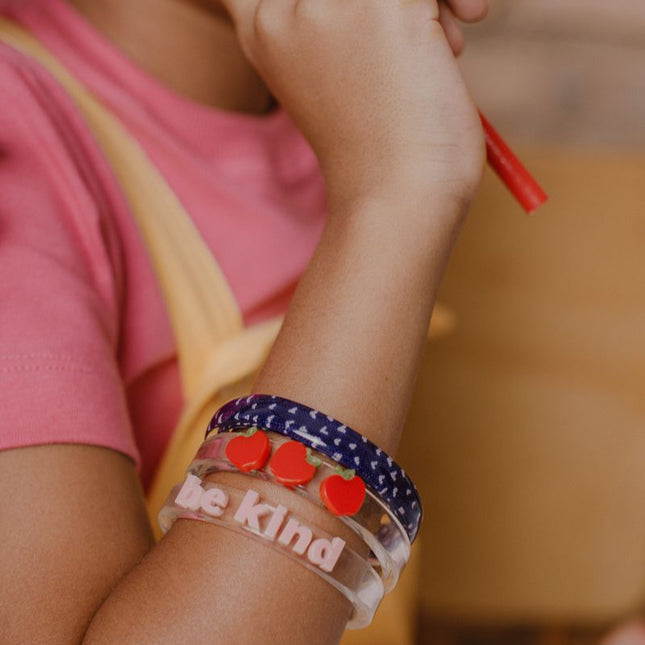 Girl wearing "Be Kind" Apple Bangles 
