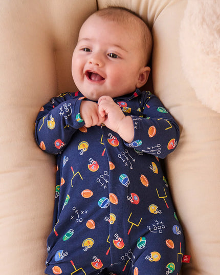 Baby wearing football print navy polo romper