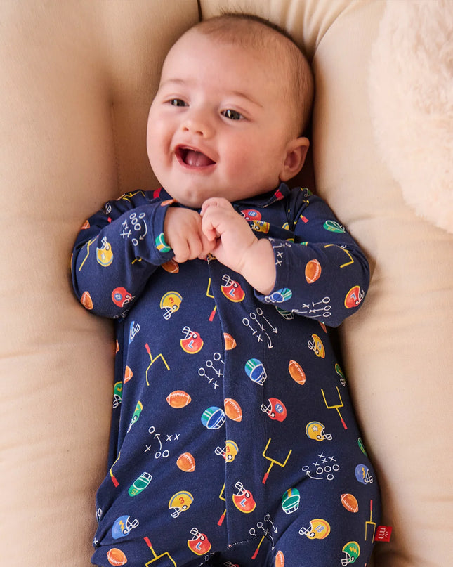 Baby wearing football print navy polo romper