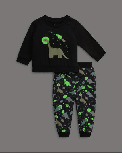 A two-piece kids lounge set featuring a black long-sleeve top with a dinosaur and space graphic, paired with black pants covered in a colorful dinosaur space print.