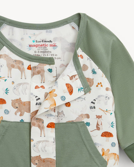 Baby romper with green raglan sleeves, pockets, and cuffs, featuring an all-over woodland animal print.