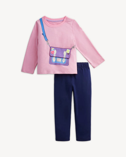 A children's two-piece outfit featuring a pink long-sleeve top with a purple purse and navy blue pants