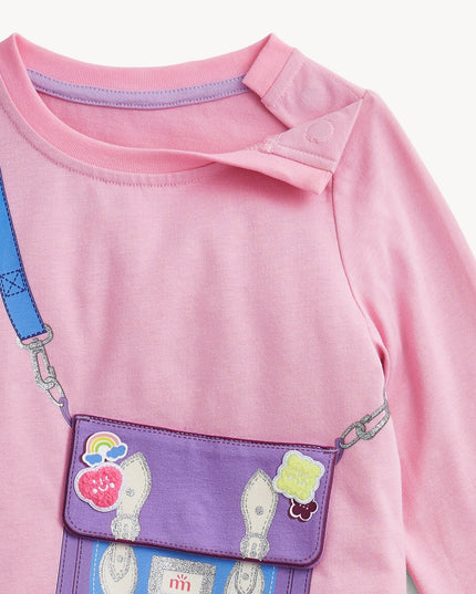Close up of a children's pink long-sleeve top with a purple purse 