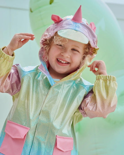 Girl wearing rainbow unicorn sparkle raincoat with magnetic closures