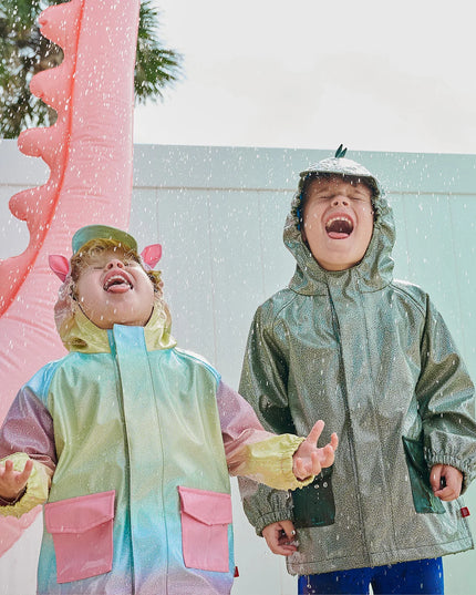 kids wearing unicorn and dinosaur raincoats