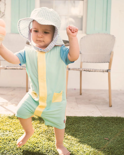 Child wearing blue, green and yellow magnetic romper