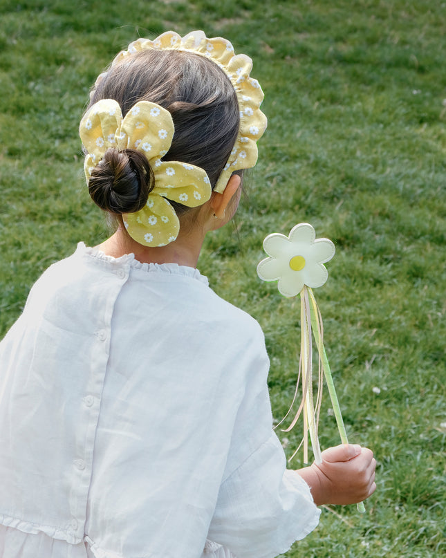 Girls holding daisy wand with streamers