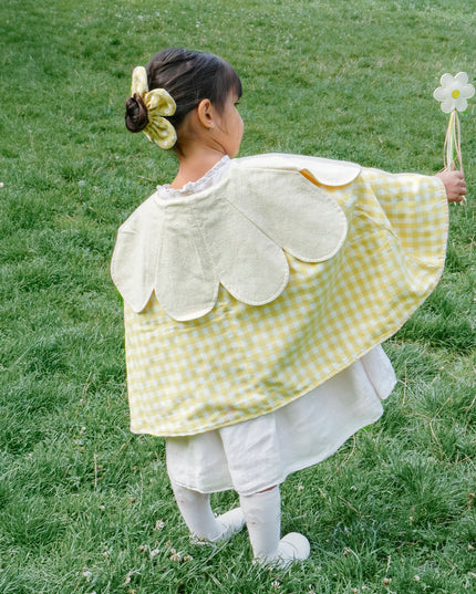 Girls holding daisy wand with streamers